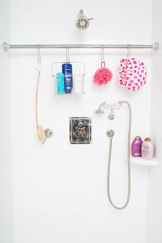 Shower items hanging from extra curtain rod in shower