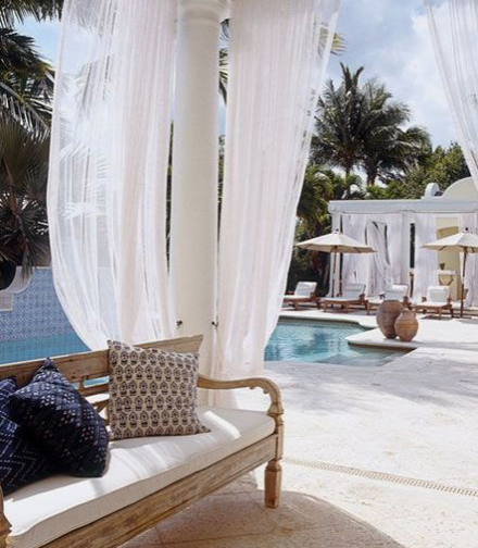 Flowy curtains next to a pool