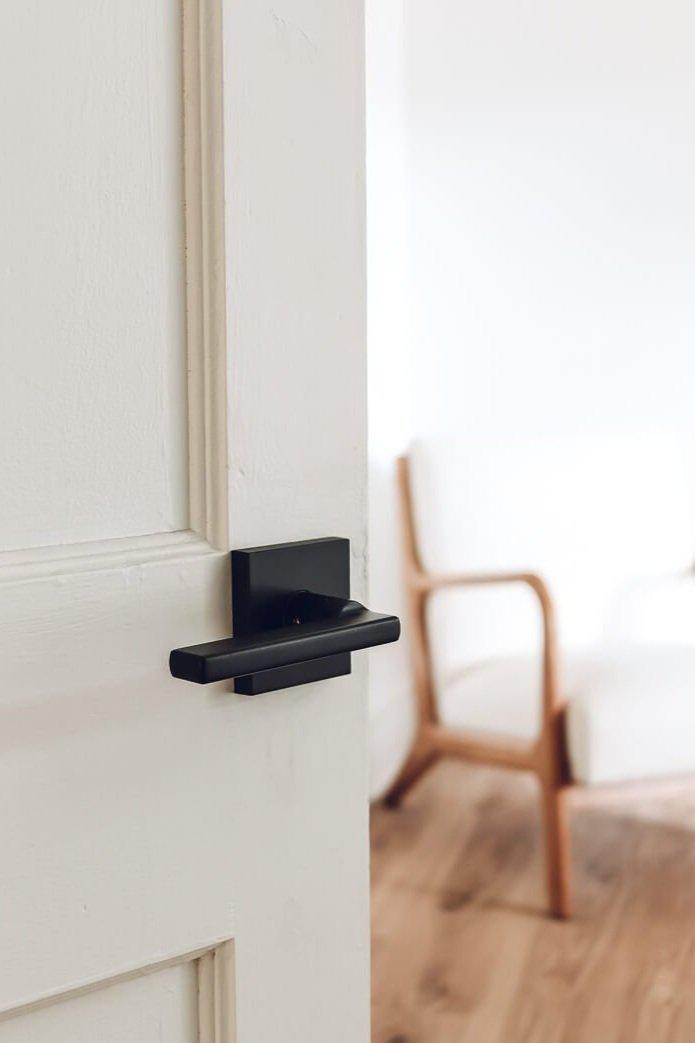 Black door knob on a white door