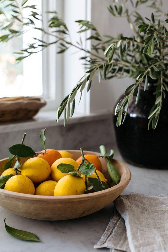 Lemons and oranges in a bowl on a counter