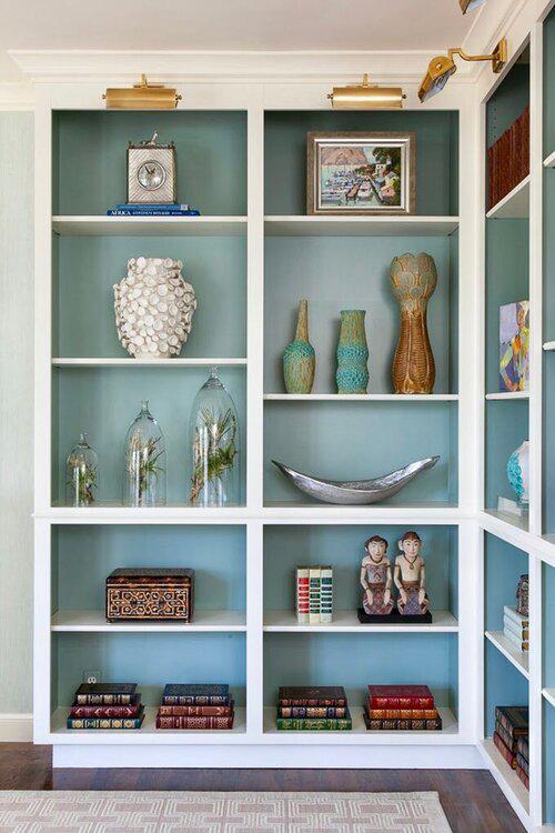 Wall with shelves painted with a soft blue backing