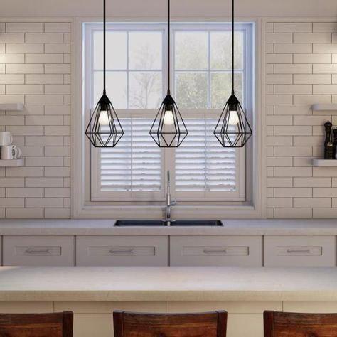 A kitchen with three light fixtures